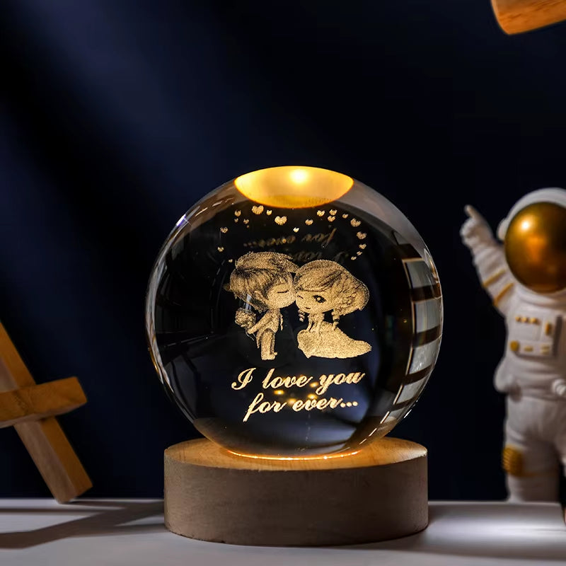 Glass ball with engraved couple and 'I love you for ever' text, illuminated from within.