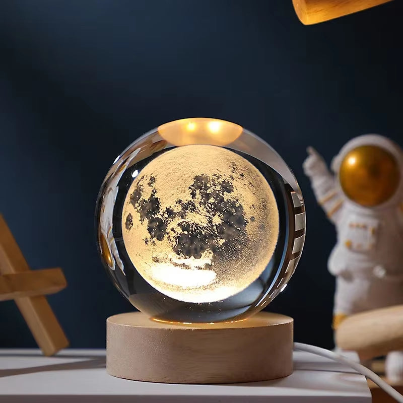Moon lamp on a wooden base with an astronaut figurine in the background